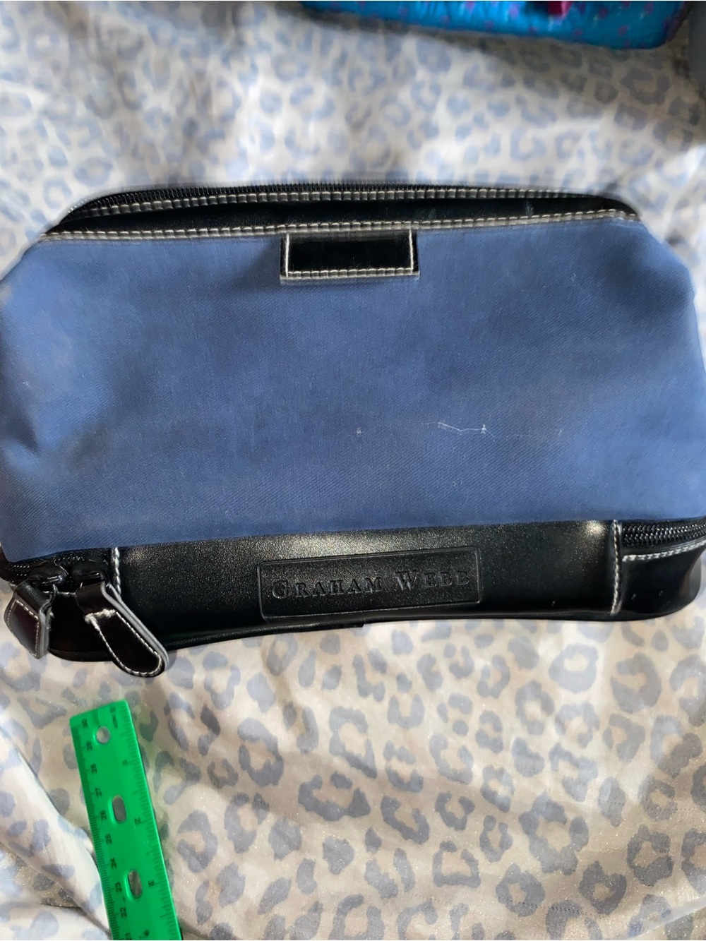 Blue canvas and black faux leather cosmetic or toiletry bag
